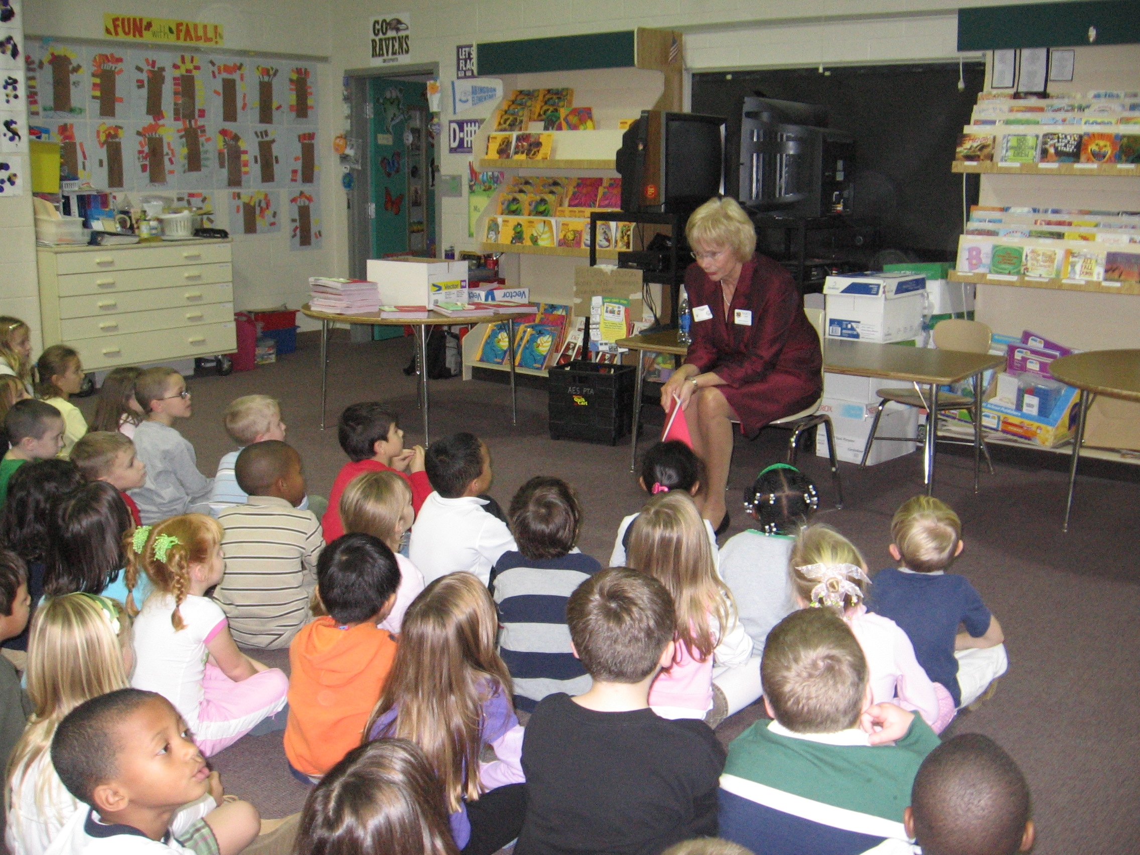 Senator Nancy Jacobs sits in front of a group of Abingdon Elementary students speaking to them on the importance of voting.
